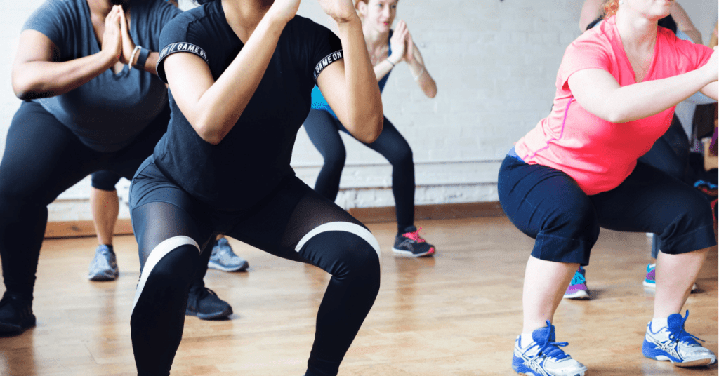 women squatting in a fitness class